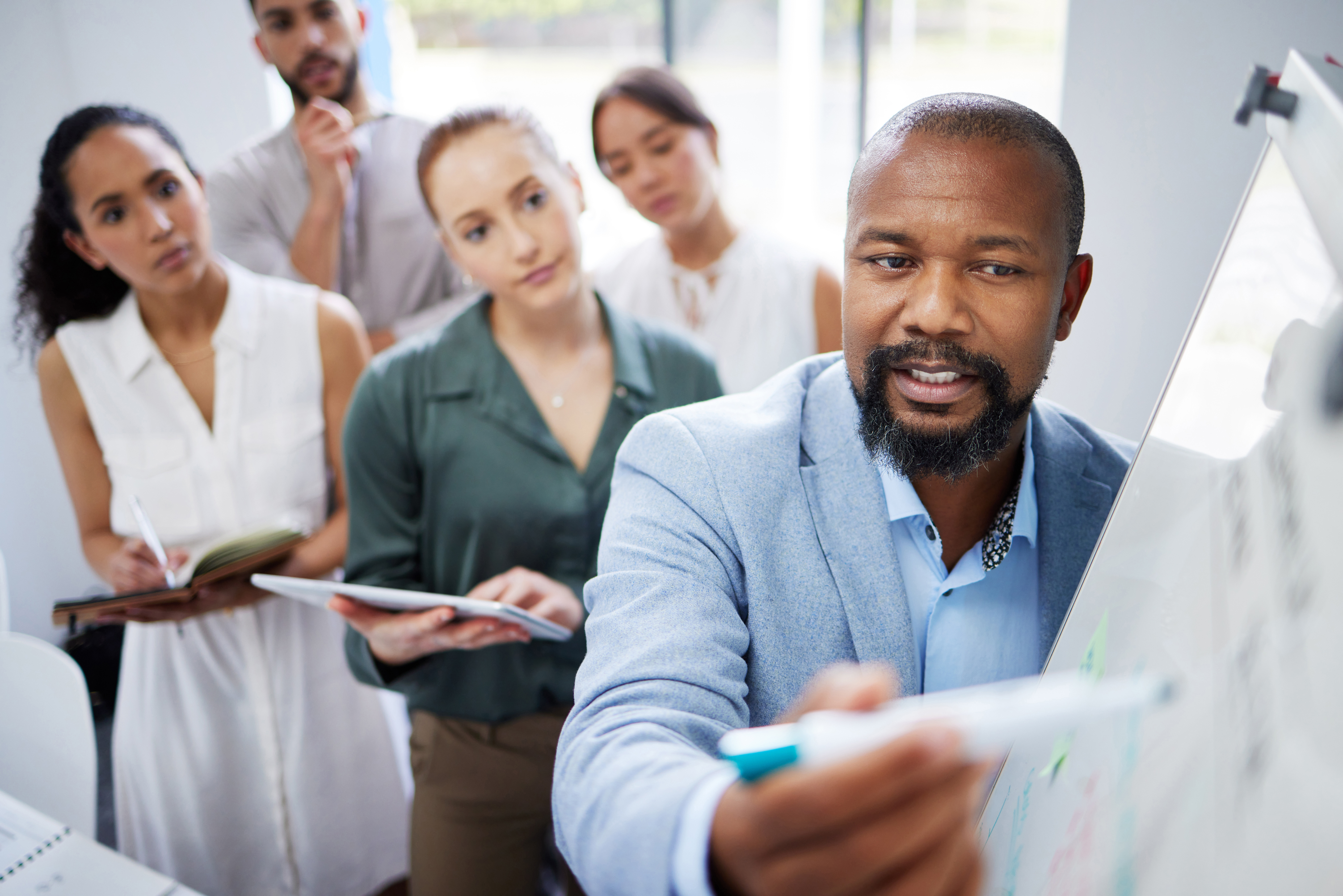 Leadership and management trainer leading a team