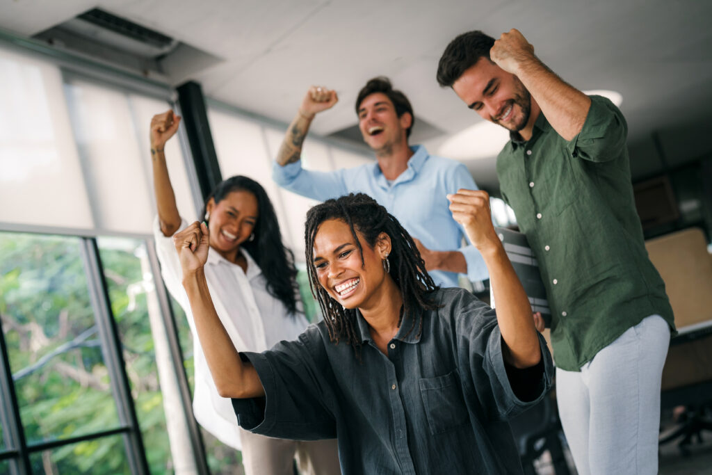 A group of business consultants raising their fists